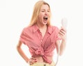 Angry sad blonde woman holding telephone tube. Phone call. Woman shouting a phone, listen bad news. Screaming woman face Royalty Free Stock Photo