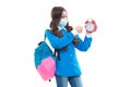 Angry school child in face mask punch alarm clock during COVID-19 disease pandemic, ultimatum