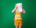 Angry school girl hiding behind bad grade test