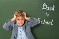 Angry schoolboy holding his head Royalty Free Stock Photo