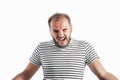 Angry screaming bearded adult rage man in a striped T-shirt. 30-35 years old. Isolated on white