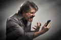 Angry screaming man with cell phone. Royalty Free Stock Photo