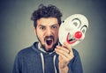 Angry screaming man holding a clown mask Royalty Free Stock Photo