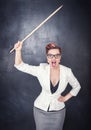 Angry screaming teacher with pointer on blackboard background Royalty Free Stock Photo