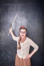 Angry screaming teacher with pointer on blackboard background Royalty Free Stock Photo