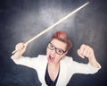 Angry screaming teacher with pointer on blackboard background Royalty Free Stock Photo