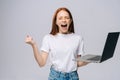 Angry screaming young business woman or student with opened mouth holding keeping laptop computer Royalty Free Stock Photo