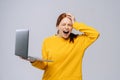 Angry screaming young business woman or student with opened mouth holding keeping laptop computer Royalty Free Stock Photo