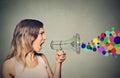 Angry screaming young woman holding megaphone