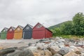 Angry seagull is flying above boathouses. multi-colored garage wooden houses in coastal Norwegian fishing village Royalty Free Stock Photo