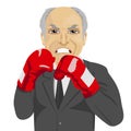 Angry senior businessman with boxing gloves wearing gray suit Royalty Free Stock Photo