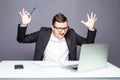 Angry senior businessman sitting at his desk and screaming. Angry businessman with too much work in office. Handsome stressed youn Royalty Free Stock Photo