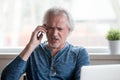 Angry senior man arguing talking on phone complaining on problem