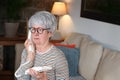 Angry senior woman using landline telephone Royalty Free Stock Photo