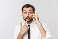 Angry and serious businessman talking on the phone over gray background Royalty Free Stock Photo