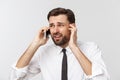Angry and serious businessman talking on the phone over gray background Royalty Free Stock Photo