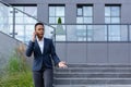 Angry and serious businesswoman talking on the phone outside the office, African American woman dressed in business clothes, Royalty Free Stock Photo