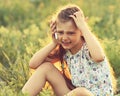 Angry serious cute kid girl sitting on the glass, talking on mob