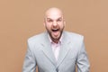 Angry or shocked bald bearded man standing, looking at camera and screaming, arguing with friend. Royalty Free Stock Photo