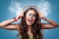 Angry shocked girl in headphones listening to music. Royalty Free Stock Photo