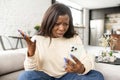 Angry stressed multiracial woman having unpleasant video call conversation, talks on the smartphone online and arguing Royalty Free Stock Photo