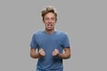 Angry stressed teen boy shouting on gray background. Royalty Free Stock Photo