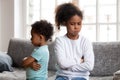 Angry stubborn african sister and offended brother ignoring each Royalty Free Stock Photo