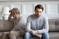 Angry adult son and old father avoid talking after fight Royalty Free Stock Photo