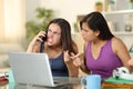 Angry students claiming on phone at home Royalty Free Stock Photo