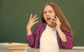 angry teen girl speaking on mobile phone in high school at blackboard, conversation Royalty Free Stock Photo