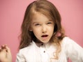 Portrait of angry teen girl on a pink studio background Royalty Free Stock Photo