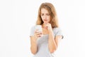 Angry teen woman in grey shirt shouting on smartphone over white background, bad news reading Royalty Free Stock Photo