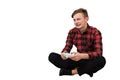 Angry teenage boy playing video games isolated over white background. Upset adolescent guy seadted on the floor holding a joystick Royalty Free Stock Photo