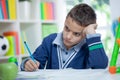 Angry and tired schoolboy studying Royalty Free Stock Photo