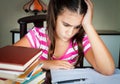 Angry and tired schoolgirl studying