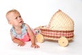 Angry toddler girl is lying next to the stroller toy Royalty Free Stock Photo