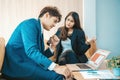 Angry and unhappy asian businesswoman arguing with businessman about work failure at office. Royalty Free Stock Photo