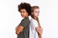 Angry upset kids standing back to back with crossed hands Royalty Free Stock Photo