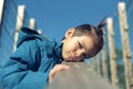 Angry and upset little boy leaning his head on wooden railing Royalty Free Stock Photo