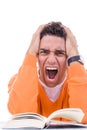 Angry and upset young man in sweater reading book Royalty Free Stock Photo