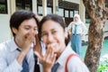 angry veiled girl stand when a boy whispered to a girl in high school uniform Royalty Free Stock Photo