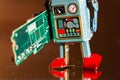 Tin toy robot carries computer circuit board, artificial intelligence concept Royalty Free Stock Photo