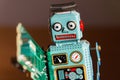Tin toy robot carries computer circuit board, artificial intelligence concept Royalty Free Stock Photo