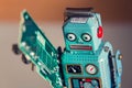 Tin toy robot carries computer circuit board, artificial intelligence concept