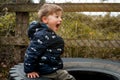 An angry wild child boy screams at the camera, ready to fight. Tantrums and disobedience crisis of three years and self