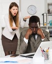 Angry woman boss pointinting to misses in work to man manager working Royalty Free Stock Photo