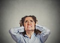 Angry woman covering ears looking up stop loud noise Royalty Free Stock Photo