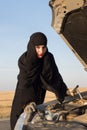 Angry woman driver with repair keys near broken car