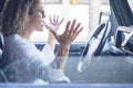 Angry woman driver shout in the traffic - stressed adult people inside car vehicle - hands off of steering wheels safety concept