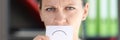 Angry woman holding card with negative emotion in front of her mouth. Royalty Free Stock Photo